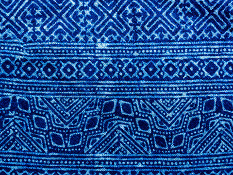 Indigo blue fabric tie dye pattern background. Indigo-Dyed fabric texture with abstract ethnic graphic motif pattern.