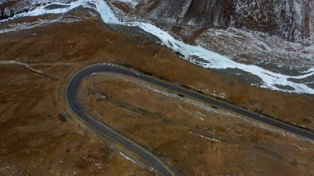 Car Drives Through The Curve In Karakoram Highway In Pakistan. aerial
