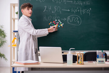 Schoolboy studying chemistry in the classroom