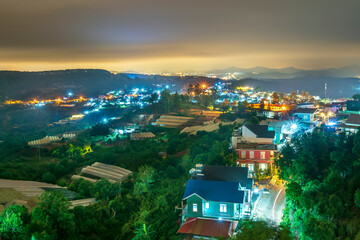 Night scene in the valley with bright houses with colorful lights makes the night scene in the countryside Vietnam