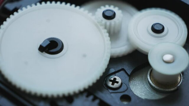 Internal Working Mechanism with Rotating Gears. Rotating black and white Plastic gears. Servomotor machinery in motion. Industrial construction. Teamwork concept