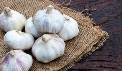 Fresh garlic on wooden background.