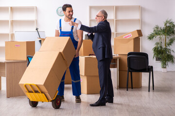 Old businessman and young contractor in relocation concept