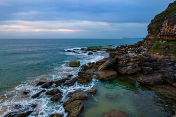 Soft high cloud aerial sunrise seascape and headland