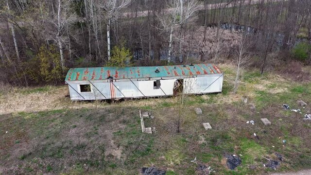 Abandoned rusty trailer near highway drone shot