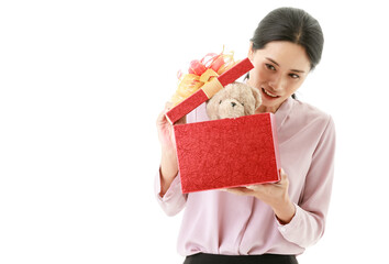 Portrait closeup isolated cut out shot of young happy Asian female housewife stand smiling open and hold cover of red birthday celebration present gift box of teddy bear doll from husband in hands