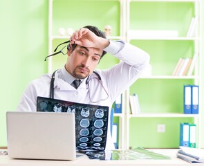 Doctor radiologist looking at x-ray scan in hospital