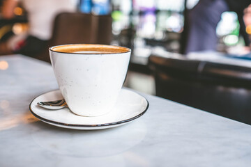 A cup of coffee with latte art in the coffee shop.