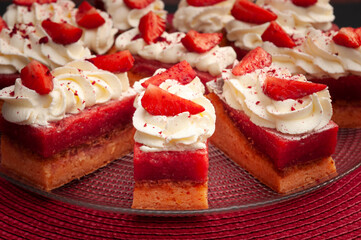 strawberry cake with white cream, on red background, front image