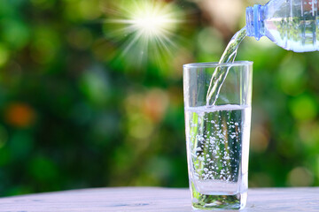 Drinking water and a glass of mineral water, health care concept, space for text