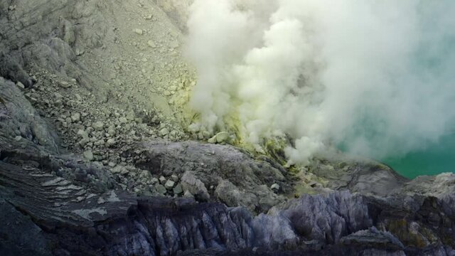 Slow Motion Panning Steam As It Rises From The Caldera Of Ijen Volcano, With A Rough And Rocky Landscape - East Java, Indonesia