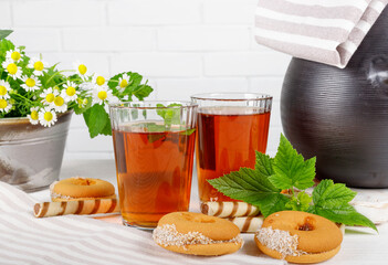 Two cups of hot tea with delicious cookies on  wooden table.