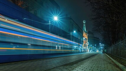 Ulica Basztowa w Krakowie z domem pod globusem w nocy - widoczne tramwaje - obrazy, fototapety, plakaty