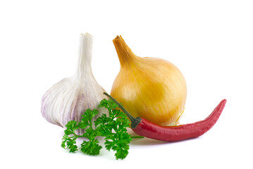 Garlic, onion, parsley and chili pepper on white