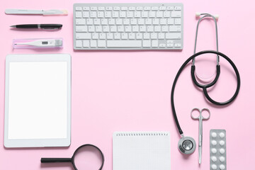 Frame made of modern stethoscope, tablet computer and keyboard on color background