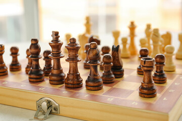Chess pieces on game board, closeup