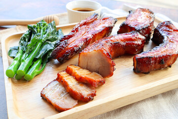 Char Siu - Honey barbecue roast pork on wood tray of wood table - Chinese style grilled pork at...