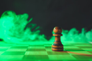 Chess board with pawn and smoke on dark background