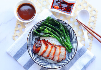 Chinese barbecue roast pork (Char Siu) and Chinese broccoli rice bowl  - Top view on marble table