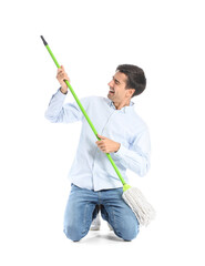 Young man with floor mop on white background