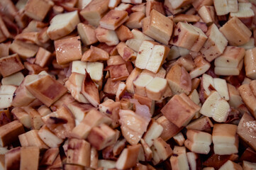 Pieces of sea cuttlefish squid cut into cubes. Ready-made ingredients for sea salad