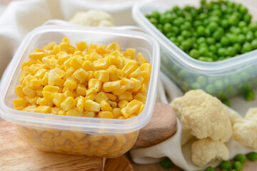 Plastic containers with vegetables on table, closeup