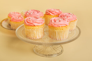 Dessert stand with tasty cupcakes on color background, closeup