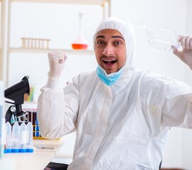 Young chemist student working in lab on chemicals