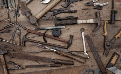 Collection of antique woodworking handtools on a rough workbench old wooden