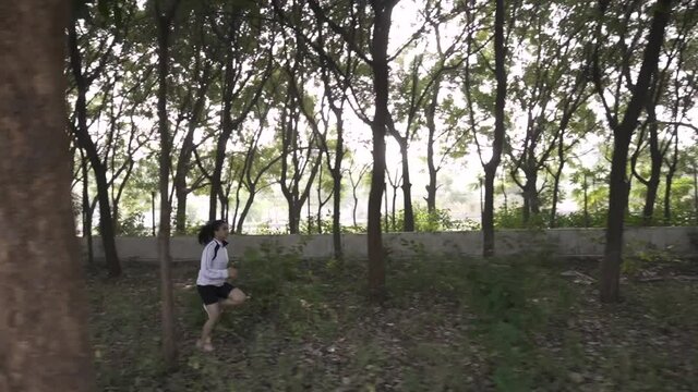 Woman jogging or running, Running concept, Strong and fit athletic. Girl wearing sportswear doing fitness activities outdoors. healthy lifestyle fitness sporty woman runner running in forest