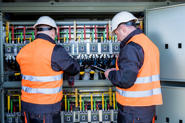 Checking the operating voltage levels of the solar panel switchgear compartment