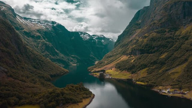 A magnificent view of the Naeroyfjord -  one of the most beautiful fjords in Norway. Forest-covered mountains tower above the narrow waterway and are reflected in mirror-like still waters. Hyperlapse.