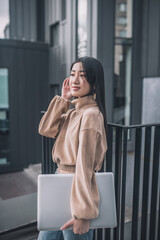 Trendy asian young woman standing outdoors and looking good