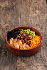 Hawaiian spicy chicken poke bowl with kimchi on purple background