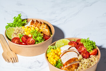 Chicken and quinoa salad with corn and tomatoes in craft eco bowl. Zero waste, to go food,...