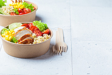 Chicken and quinoa salad with corn and tomatoes in craft eco bowl. Zero waste, to go food,...