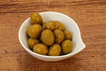 Naklejka na ściany i meble Green pickled olives in the bowl
