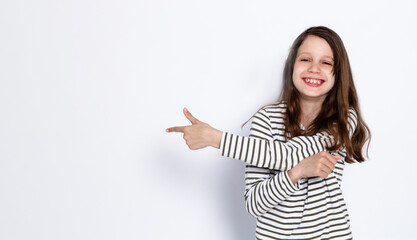 Funny dark-haired girl shows class gesture with her hands. On a light background. Space for text.