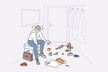 Anger and irritation concept. Young stressed man father cartoon character sitting at home feeling furious with child toys on floor putting off shoes vector illustration 