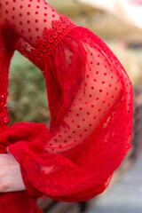close up of a red dress on sleeve