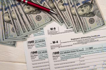 Tax Form 1040  with us 100 dollar banknotes
