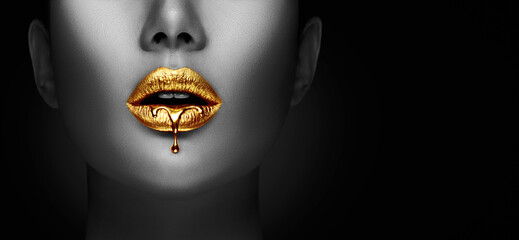 Lipstick dripping. Paint drips, lipgloss dripping from sexy lips, liquid Gold metallic paint drops on beautiful model girl's mouth, creative make-up. Desaturated Beauty woman face makeup close up. Art