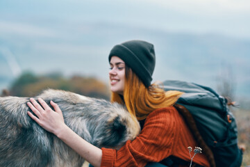 woman tourist hugs dog nature travel friendship