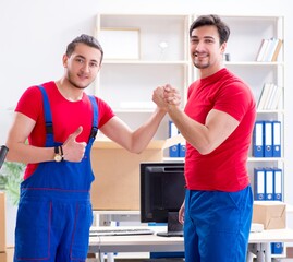 Fototapeta premium Two contractor employees moving personal belongings