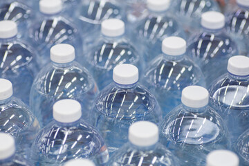 Water bottles in the supermarket. Packages of clean drinking water in plastic bottles on the...
