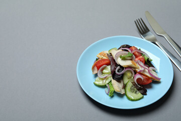 Concept of tasty eating with salad with grilled chicken on gray background