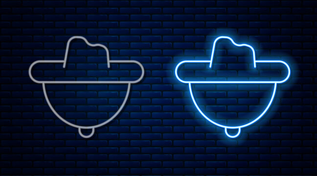 Glowing neon line Western cowboy hat icon isolated on brick wall background. Vector