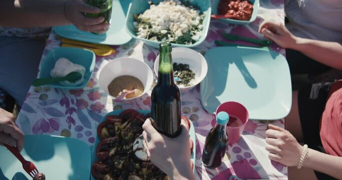 Beer toast clink in female hands full table grill bbq picnic together