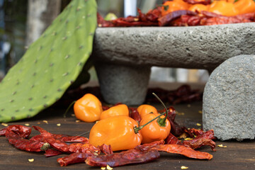 Close-up of beautiful habanero peppers surrounded by chili seeds with a background of Mexican...