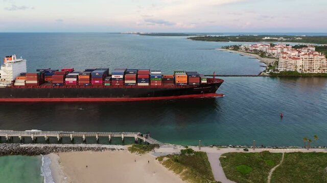 Aerial tracking shot of container ship at Miami port, Florida